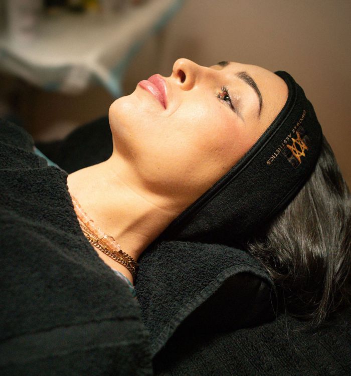 Photo of a woman laying down at a medical aesthetics spa.
